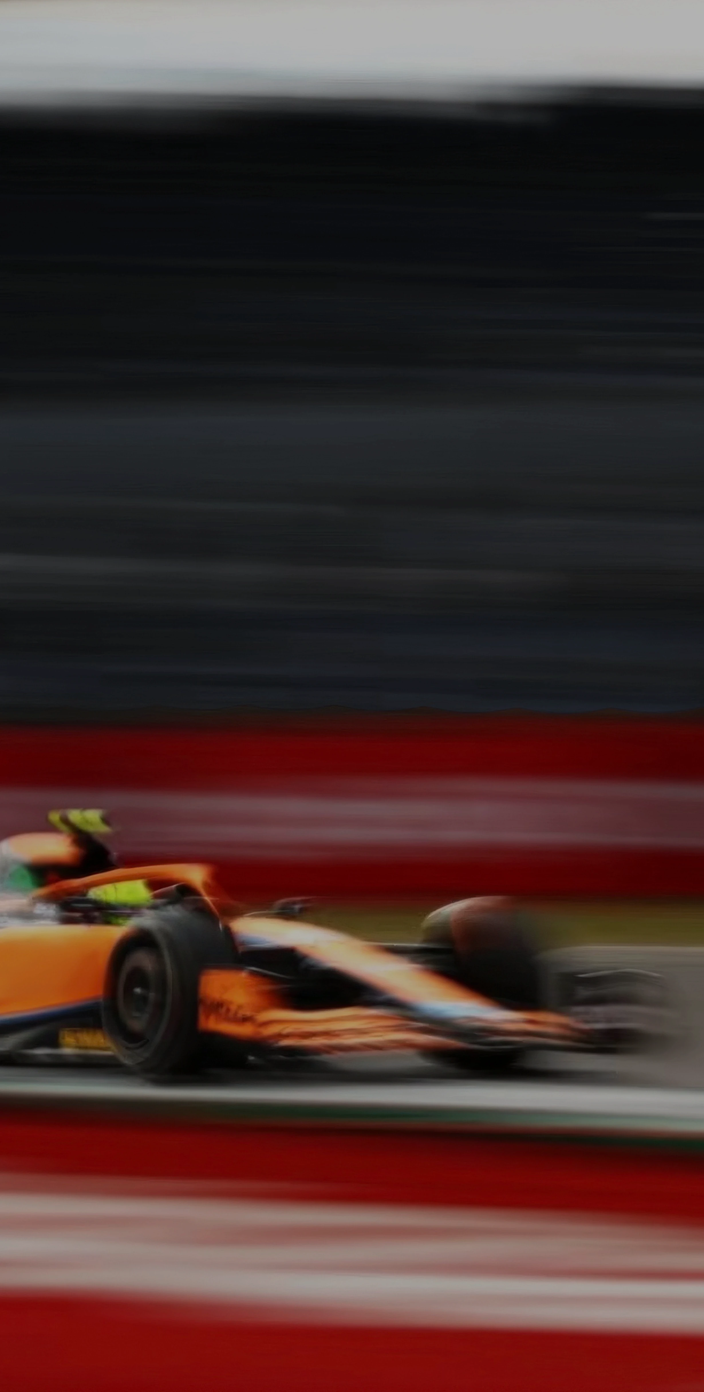 An image of a fast moving racing car blurring past at high speed at a Formula 1 racing event.